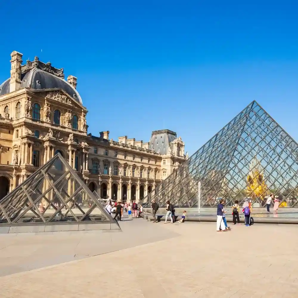 Louvre Museum exterior with iconic glass pyramid.