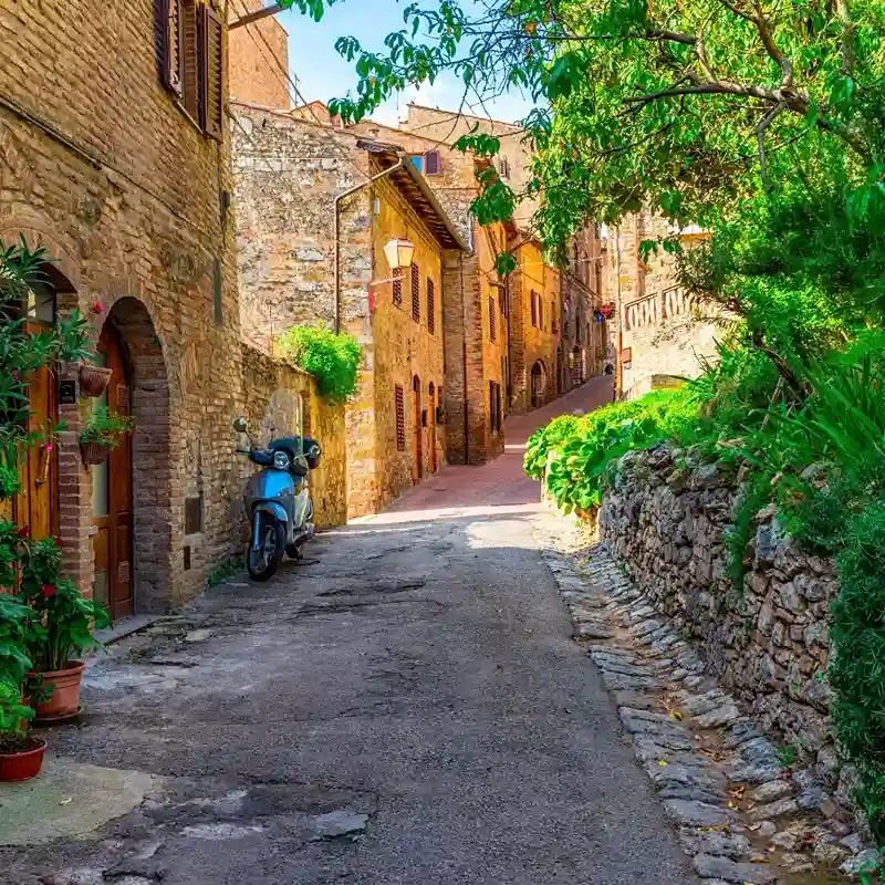 Scenic view of San Gimignano with medieval towers under a blue sky.